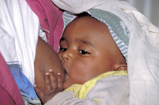 A young baby breastfeeds.